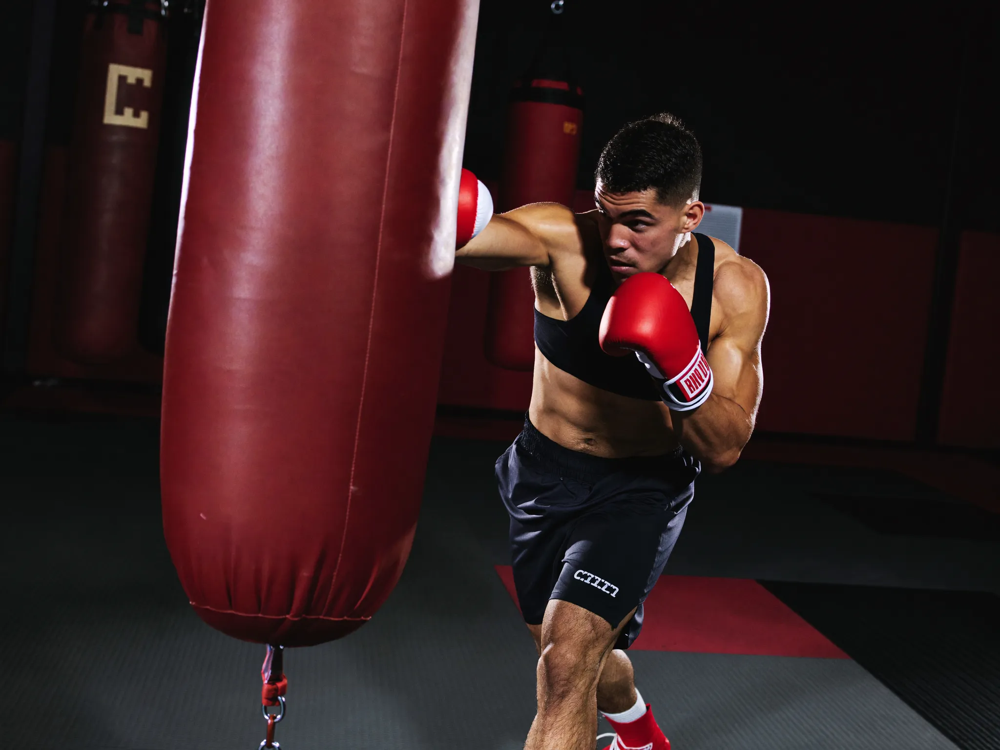 Kickboxer striking a heavy bag